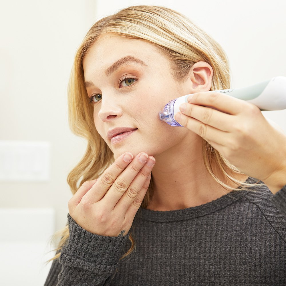 1002?Woman using Personal Microderm Classic in grey to do an at home microdermabrasion treatment