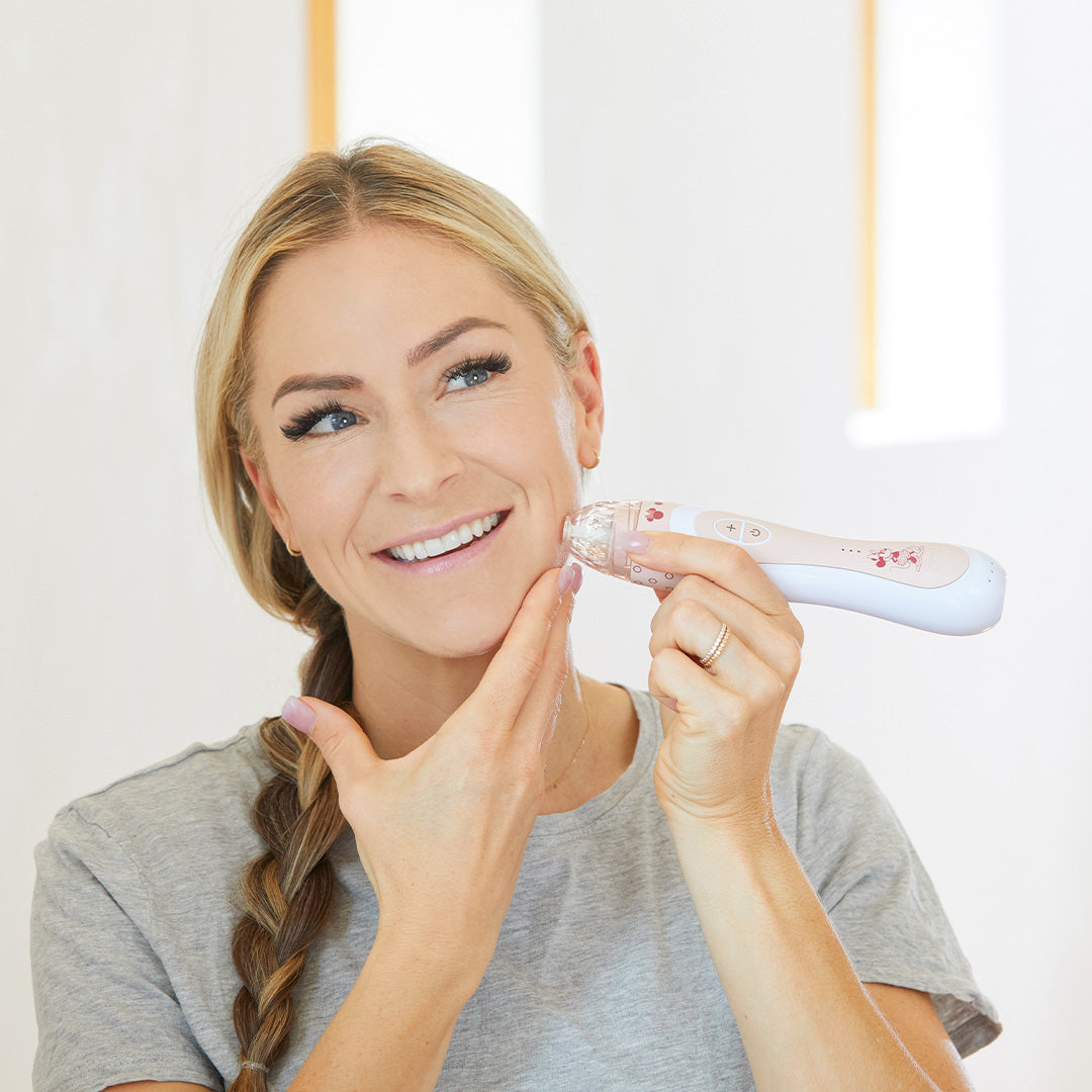 1005-MAUVE-MIN? Being used by woman on cheek