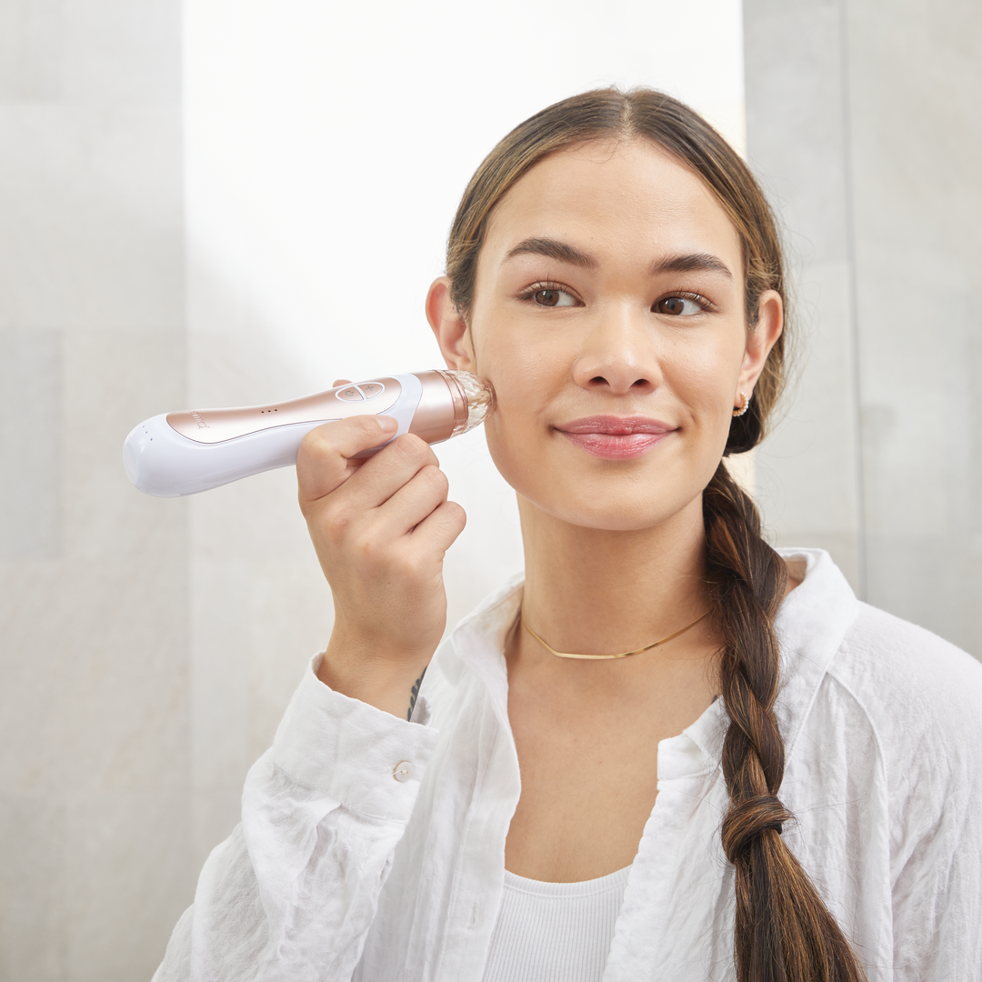 1005-RGold?Personal Microderm Elite Pro in Rose Gold being used by woman